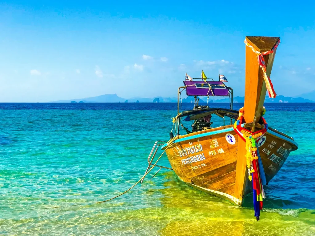 Traditional Thai boat on crystal clear waters.