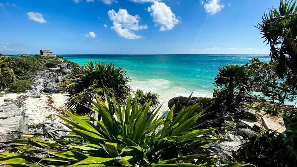 Heavenly view with turquoise sea, ancient ruins and lush vegetation.