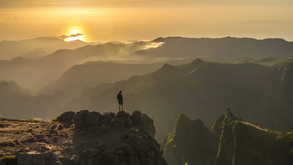 Silhouette of a person standing on a rock in Portugal.